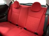 the seat covers are red and black in the back of a car