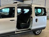 a white van with its doors open in a garage