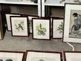 a lot of framed pictures on the floor of a room