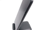 a cell phone on a stand on a white surface
