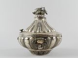 an antique silverplated sugar dish with a lion head on the lid