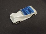 a toy car that is sitting on a black surface