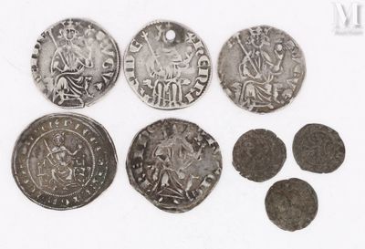 several silver coins are arranged in a row on a white surface