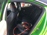 a green car with an air conditioner in the back seat