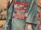 a painting of a woman in a kimono holding an umbrella