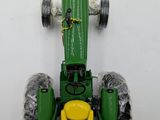 a toy tractor that is sitting on a white surface