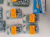 many different types of screws and nuts on the table
