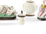 four different types of porcelain figurines displayed on a table