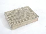 a silver box that is sitting on a white surface