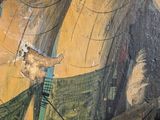 a painting on the wall of a building that has a picture of a man on it