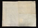 a close up of a piece of paper on a black surface