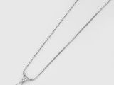 a close up of a necklace on a white surface