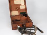 an old wooden box with tools in it on a white surface