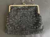 a black and white beaded purse on a table