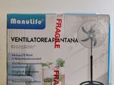 une boîte contenant un ventilateur et un ventilateur de table posés sur la table