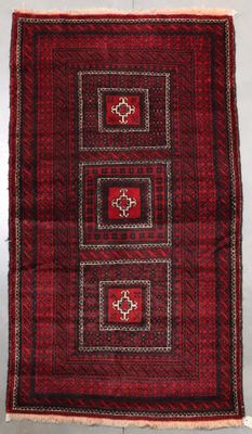 a red and black rug with four squares on it