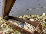 a person opening a wooden box with a glove in it