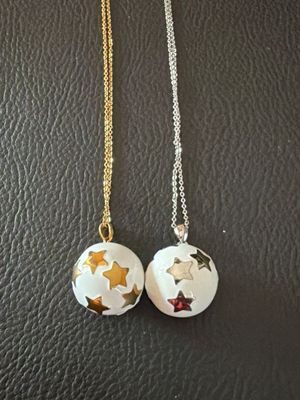 a pair of white and gold stars on a black leather surface