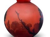 a red vase with a tree on it on a white background