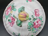 a white bowl with flowers and a bird painted on it