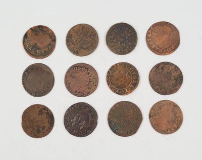 a close up of a bunch of coins on a white surface