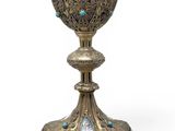 an image of a silver cup with blue stones on it