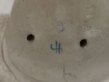 a close up of a white vase with blue writing on it