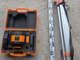un ensemble d'outils posé sur le sol en béton, à côté d'un mètre ruban