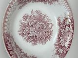a red and white plate and a bowl on a table