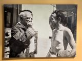 a black and white photo of a man and a naked man