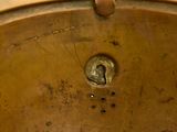 a close up of a metal pan with a hole in it