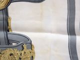 an image of a chair with a gold and black design