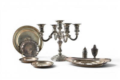 a silver plate with a candelab and a silver plate with a candelab and a silver plate with a candelab and a silver plate