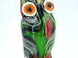 brightly colored glass owl figurine on a white background