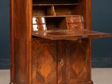 an antique wooden desk with a marble top and drawers
