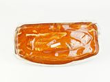 a glass container with a piece of food inside of it
