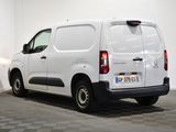 a white van parked in a room with checkered flooring