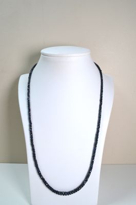 black beaded necklace on a white mannequin with a black bead