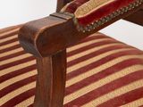 striped upholstered chair with wooden frame and arms