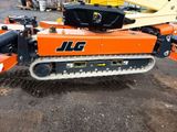 an orange and black machine that is sitting on the ground