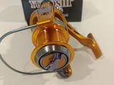 a close up of a fishing reel on a table with a box in the background