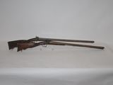 two guns are on a table with a white cloth