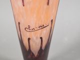 a glass vase with writing on it sitting on a table