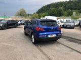 a blue car that is parked in a parking lot