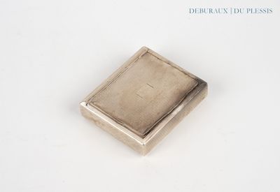 a small square silver object on a white surface