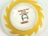 a white plate with a yellow and green design on it