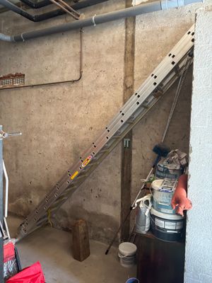 an image of a room with a ladder and a bucket