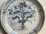 a blue and white plate with a decorative design on it