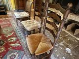 four chairs in the middle of a room with a rug on the floor