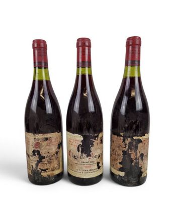 three bottles of wine sitting next to each other on a white surface